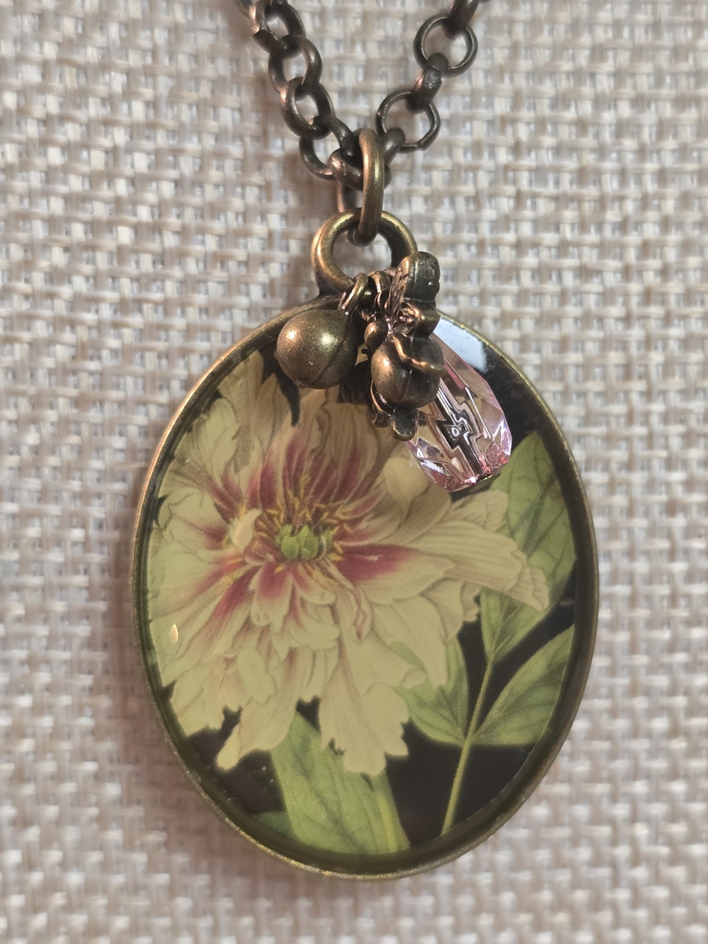 Floral Oval Pendant Necklace in Antique Gold with Pink Accent